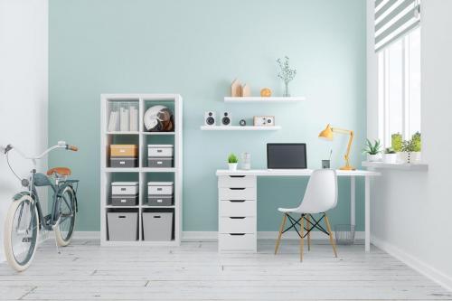 cosy home office space design with a light teal wall. 